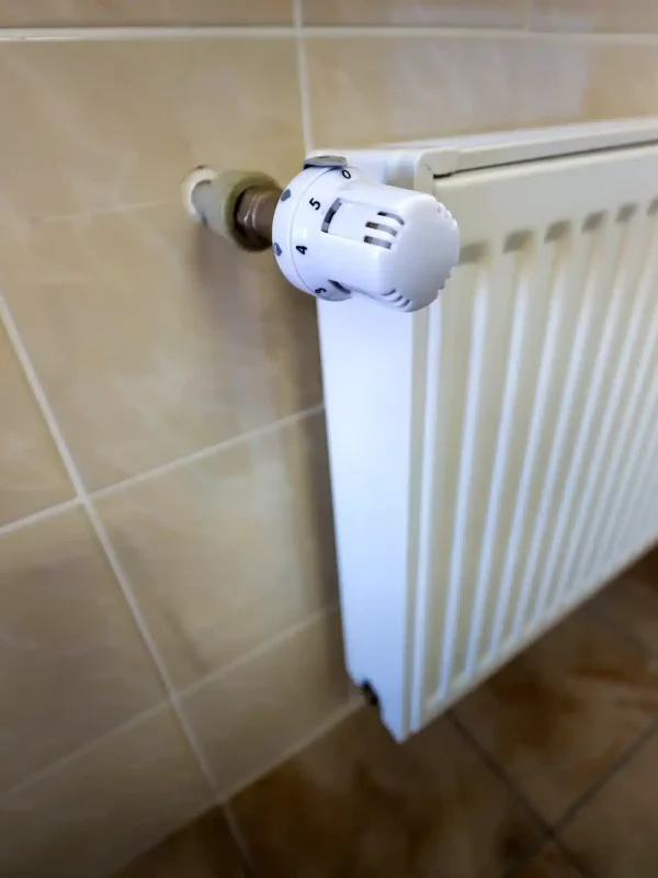 close-up-of-white-heating-radiator-with-thermostat-2024-12-06-18-06-